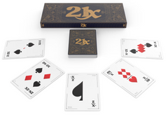 Photo of 21X box and cards laid out on a table. The box is π times as wide as it is long, and has 21X on the front. The cards visible on the table are 2-2X, 2N-2X -X/2, 4N/X and N^3-2X, and each have different combinations of symbols on representing those quantities.