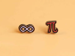 Photo of the 'Pi Infinity' style earrings, which are a red pi symbol and a pale purple infinity symbol, made from laser cut wood.
