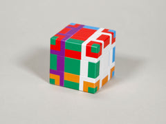 Photo of a sub cube, which has the green face visible: the corner pieces are green/white/red, green/red/purple, green/white/orange and green/orange/purple. The edge pieces are green/white, green/red, green/orange and green/purple, and the centre piece is green.