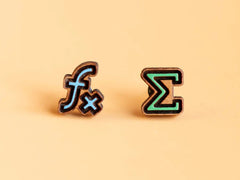 Photo of the 'Fx Infinity' style earrings, which are a pale blue f_x symbol and a pale green capital Sigma (summation) symbol, made from laser cut wood. 