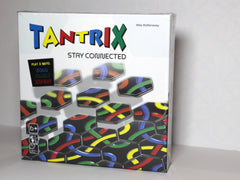 Photo of the game box, which says 'Tantrix: Stay Connected; Play 3 ways: Solo, Family, Expert' and the name of the creator Mie McManaway. Icons indicate the game is suitable for ages 6+, can be played solo or up to 6 players and takes 30 mins.