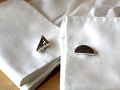 Photo of the cufflinks on a pair of shirt cuffs